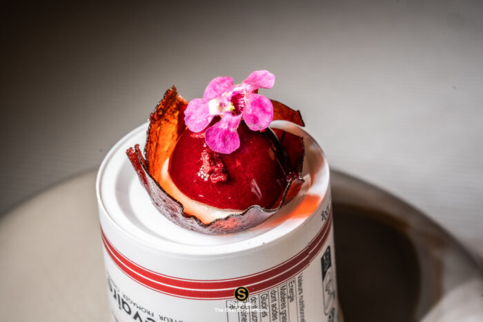 White peach and tea chocolate ganache dessert with cornflower